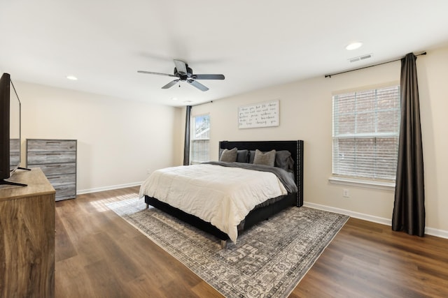 bedroom with recessed lighting, dark wood finished floors, visible vents, and baseboards