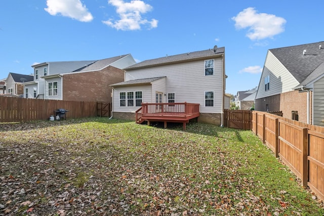 rear view of house with a yard, a fenced backyard, and a wooden deck