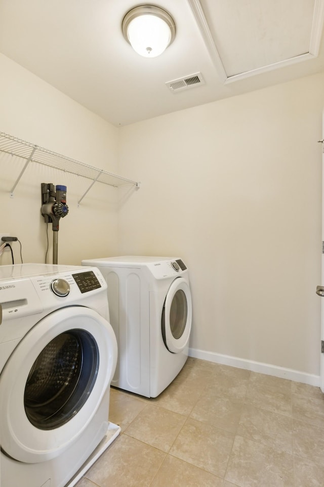 laundry area featuring laundry area, separate washer and dryer, visible vents, and baseboards