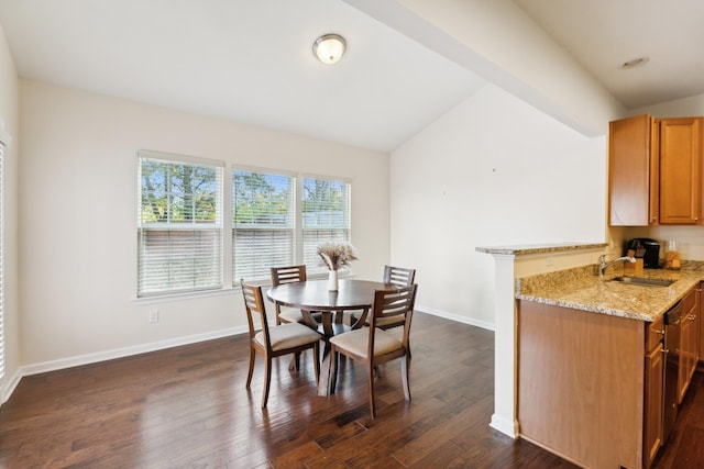 dining area with lofted ceiling, dark wood finished floors, and baseboards