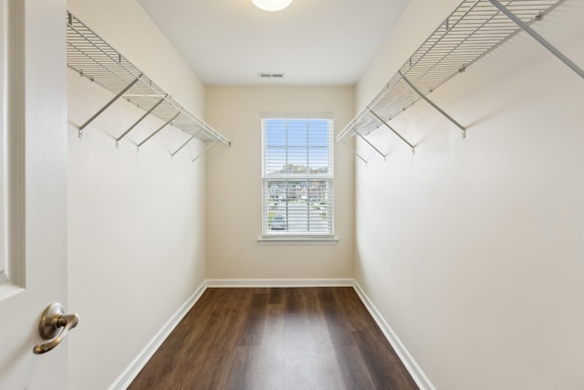 walk in closet featuring visible vents and wood finished floors