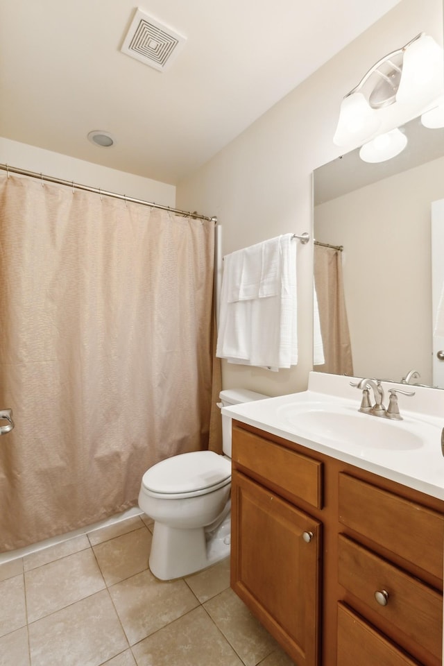 bathroom featuring a shower with curtain, visible vents, toilet, vanity, and tile patterned flooring