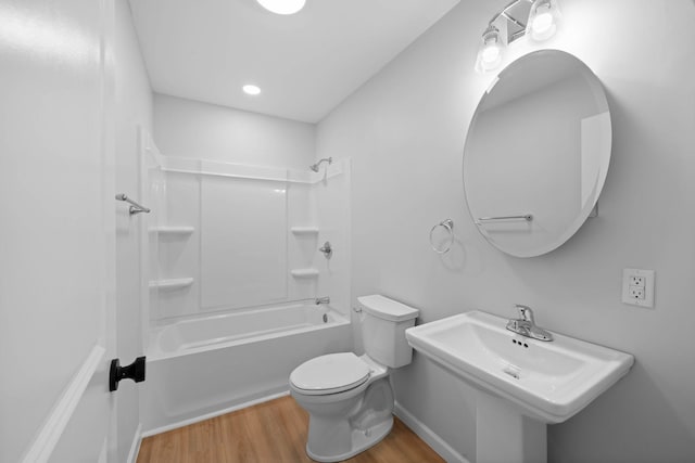 full bathroom featuring a sink, bathtub / shower combination, wood finished floors, and toilet