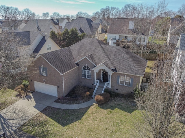 view of front facade featuring concrete driveway, a shingled roof, a front yard, and brick siding