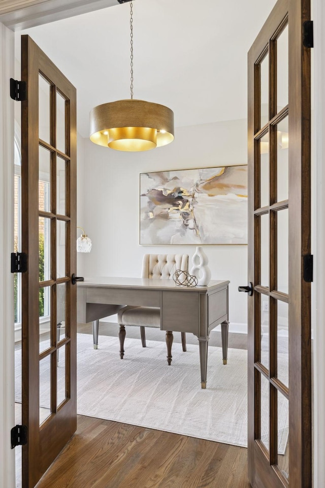 unfurnished office featuring french doors and dark wood-type flooring