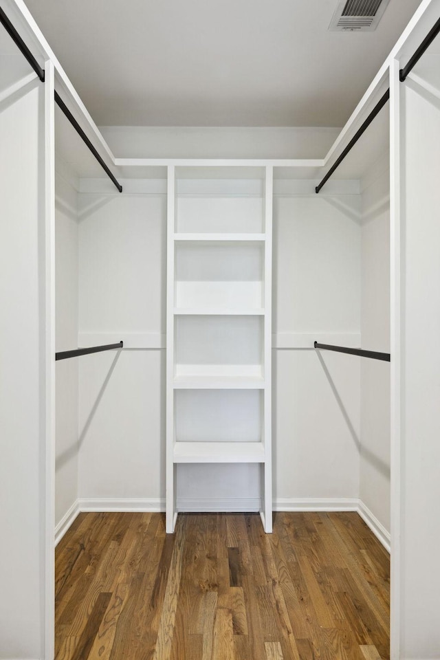 walk in closet featuring visible vents and wood finished floors