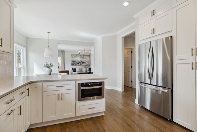 kitchen with a peninsula, dark wood-style flooring, white cabinets, appliances with stainless steel finishes, and crown molding