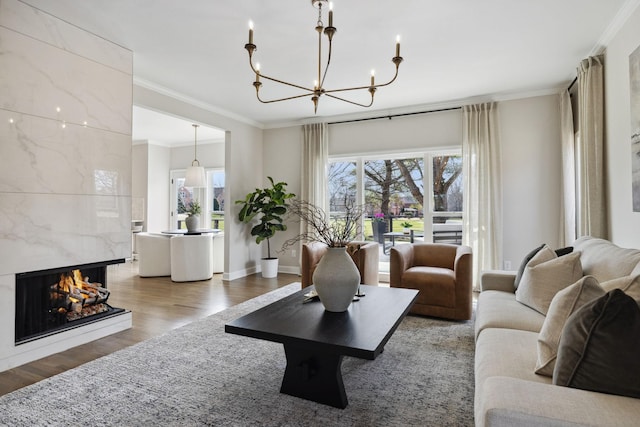 living area with a healthy amount of sunlight, wood finished floors, and a high end fireplace