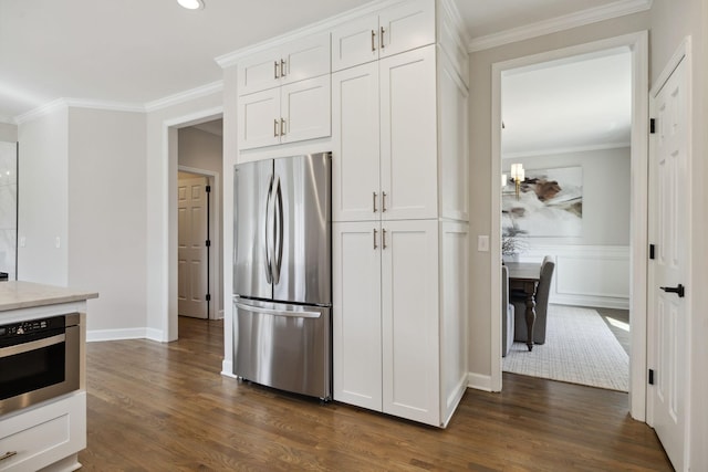 kitchen featuring ornamental molding, dark wood finished floors, and freestanding refrigerator