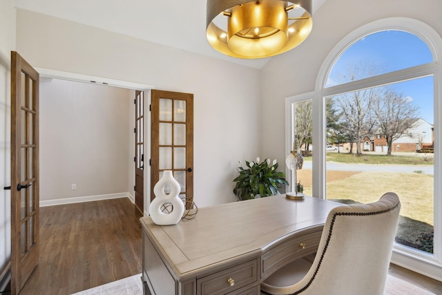 office space with baseboards, vaulted ceiling, dark wood-style flooring, and french doors