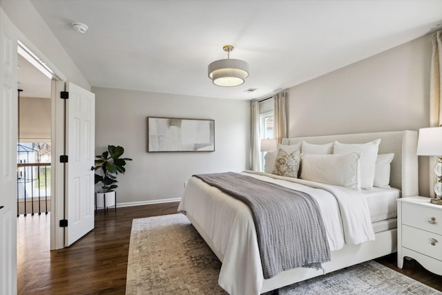 bedroom with baseboards, multiple windows, visible vents, and dark wood-style flooring