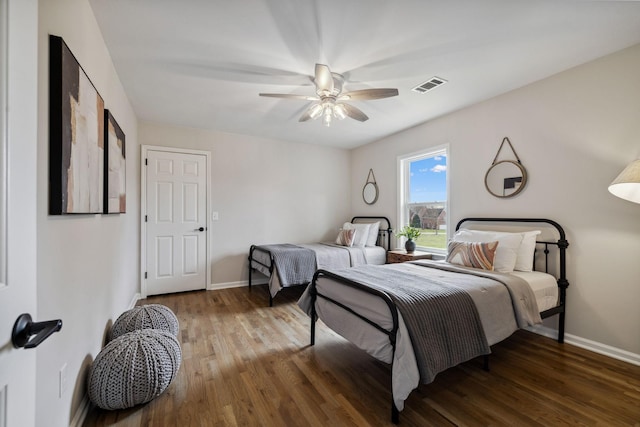 bedroom featuring visible vents, baseboards, and wood finished floors