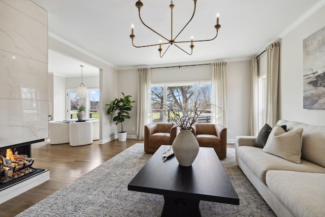 living area with ornamental molding, plenty of natural light, and wood finished floors