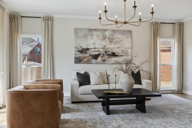 living area with baseboards, wood finished floors, and crown molding