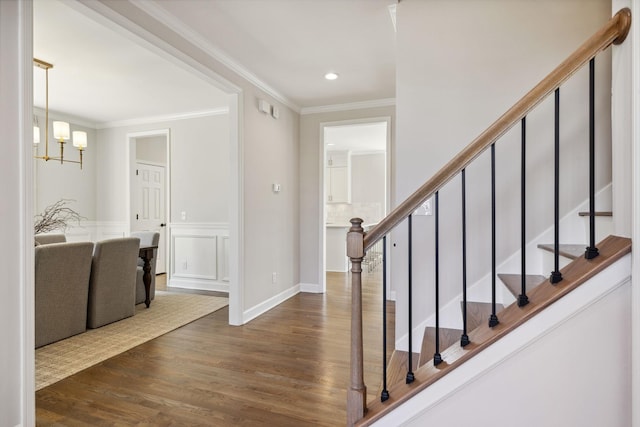 foyer entrance with recessed lighting, a notable chandelier, dark wood-style flooring, stairs, and crown molding