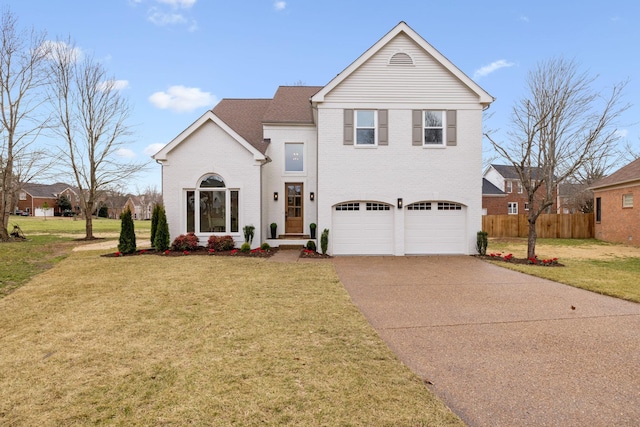 traditional-style home featuring a garage, brick siding, fence, driveway, and a front yard