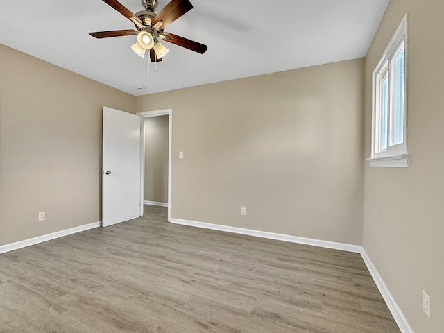 unfurnished room with ceiling fan, baseboards, and wood finished floors