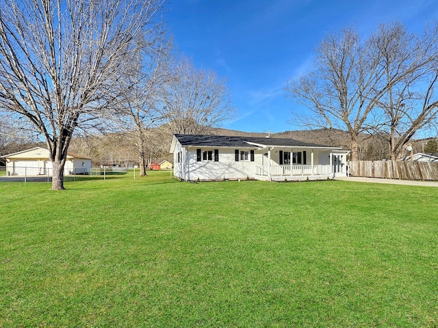 back of property with fence and a yard