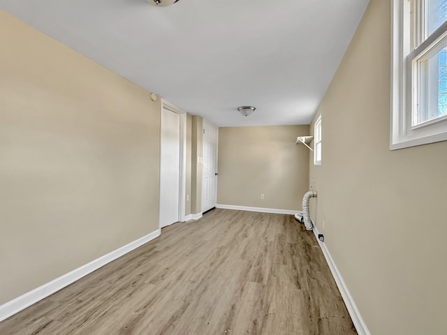 unfurnished room featuring light wood-style floors and baseboards