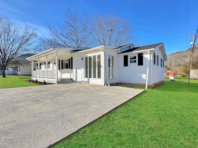 view of front of house with crawl space, covered porch, driveway, and a front yard