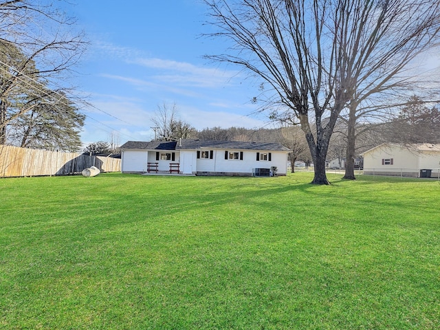 view of front of house with fence and a front lawn