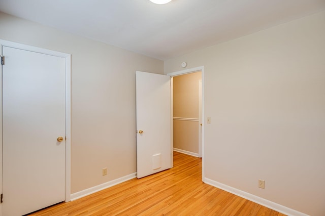 unfurnished bedroom featuring light wood-style flooring and baseboards