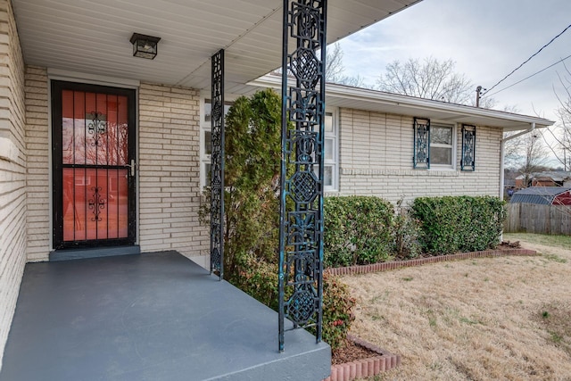 property entrance featuring brick siding