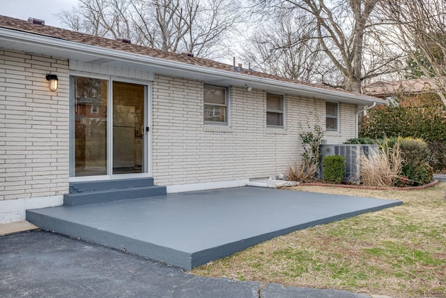 exterior space with a patio area and brick siding