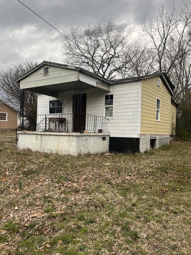 rear view of property with a porch