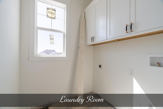 clothes washing area with hookup for a washing machine, cabinet space, and hookup for an electric dryer