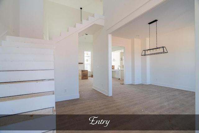 interior space featuring baseboards and wood finished floors