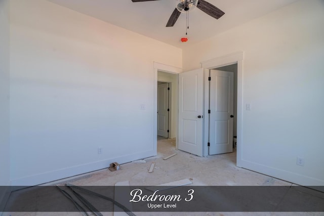 unfurnished bedroom with a ceiling fan and baseboards