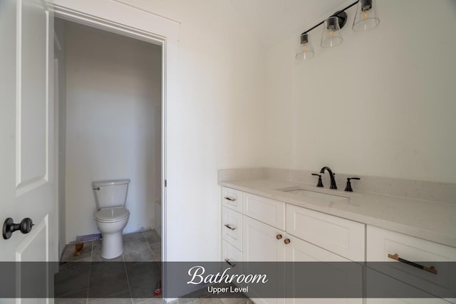 bathroom with toilet, tile patterned flooring, and vanity