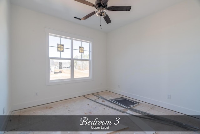 unfurnished room featuring a ceiling fan and baseboards