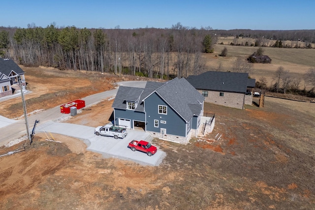 drone / aerial view with a wooded view