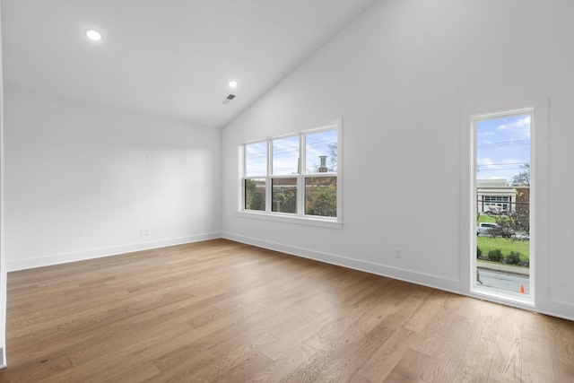 spare room featuring high vaulted ceiling, recessed lighting, visible vents, baseboards, and light wood-style floors