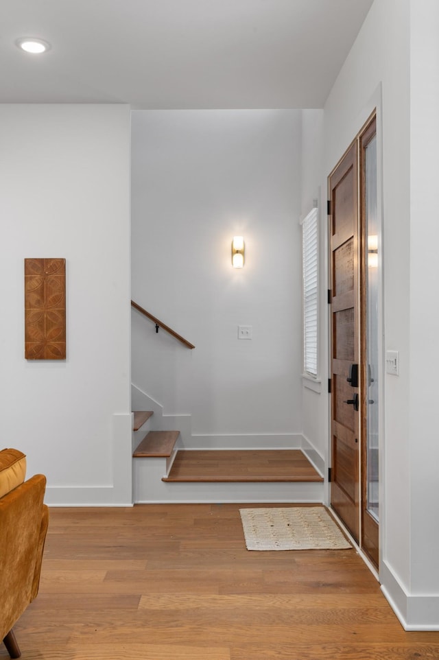 entryway featuring stairs, light wood finished floors, recessed lighting, and baseboards