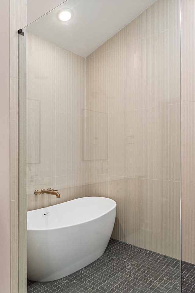 full bath featuring tile patterned flooring and a freestanding bath