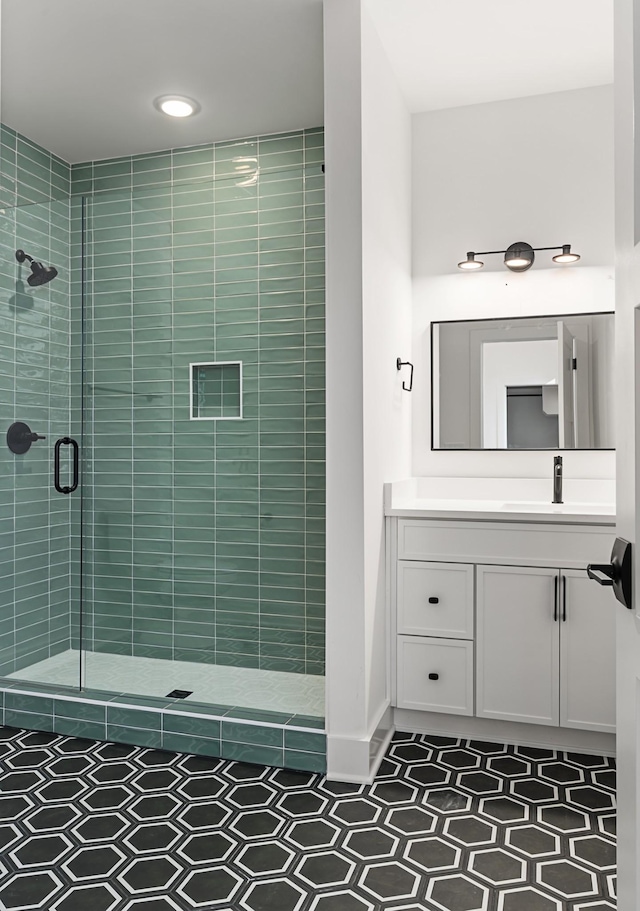 bathroom featuring a stall shower and vanity