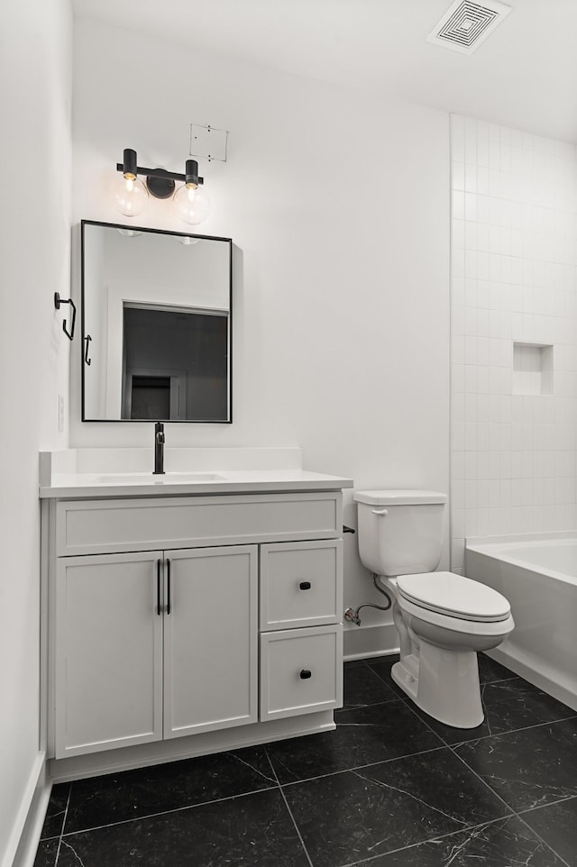 bathroom featuring toilet, vanity, visible vents, and baseboards