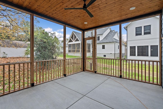 unfurnished sunroom featuring wooden ceiling, a residential view, and a ceiling fan