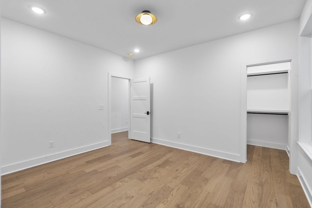 unfurnished bedroom with light wood-type flooring, baseboards, and recessed lighting