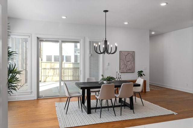 dining room with a notable chandelier, baseboards, light wood-style flooring, and recessed lighting