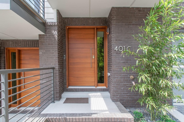 view of exterior entry with brick siding