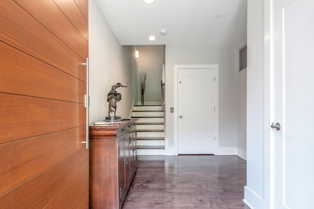 hall featuring baseboards, visible vents, stairway, dark wood-style flooring, and recessed lighting