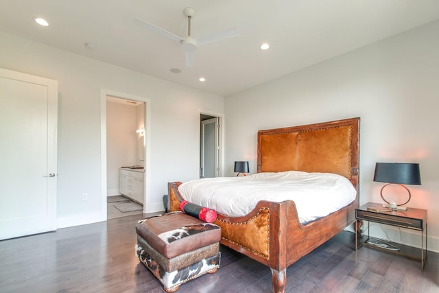 bedroom with baseboards, ensuite bathroom, wood finished floors, and recessed lighting