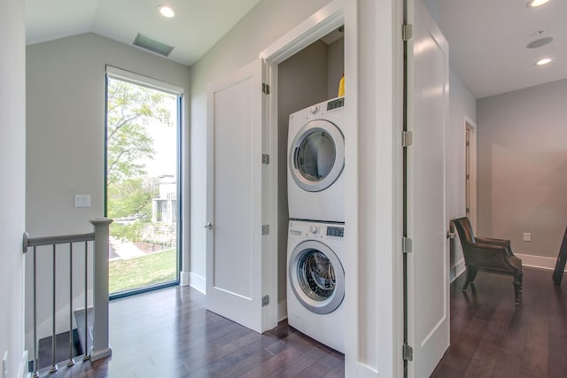 laundry area featuring stacked washer and clothes dryer, dark wood finished floors, recessed lighting, visible vents, and laundry area