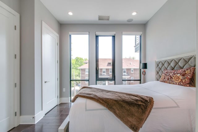 bedroom featuring dark wood-style floors, recessed lighting, and multiple windows