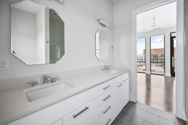 full bathroom featuring tile patterned flooring, a sink, and double vanity