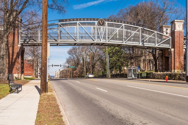 view of road with sidewalks, traffic lights, and curbs